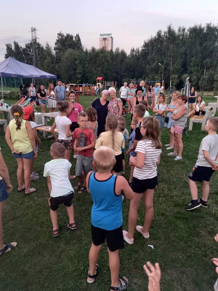 Uczetsnicy Pikniku rodzinnego przy zabawie z animatorką 