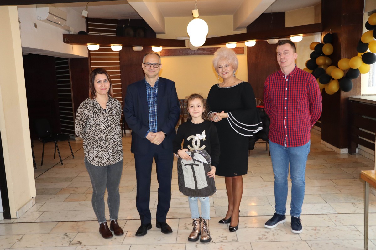 5 osób pozuje do zdjęcia z nagrodami