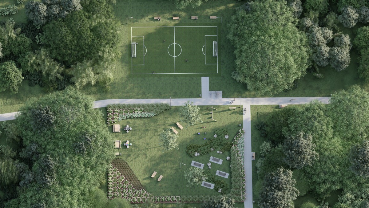 Widok na park z lotu ptaka. Widać boisko do piłki nożnej i strefę parkową na dole. Zdjęcie przecinają szare ścieżki. Całość jest usytuowana w parku, pomiędzy drzewami
